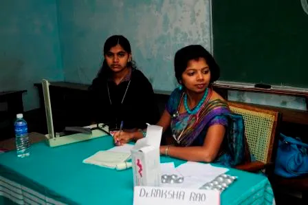 Two people at a registration desk during the camp.